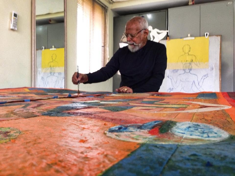 J Srividya painting at a large studio table
