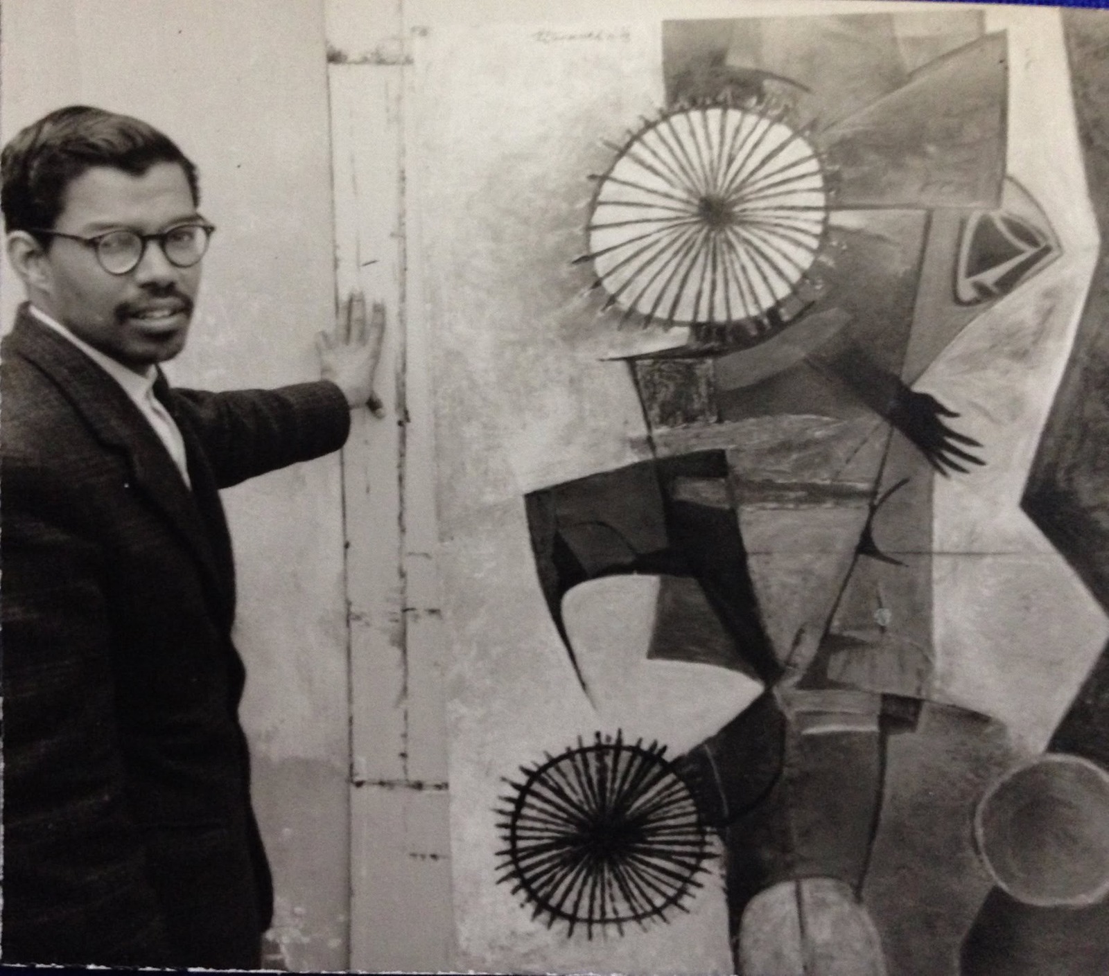 A younger J Srividya standing beside a painting